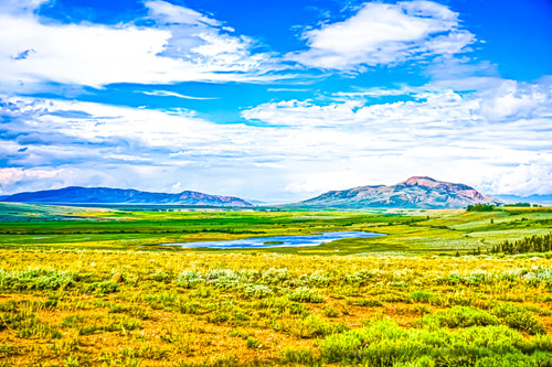 This photograph give definition to the motto, "Colorful Colorado," depicting a mixture of flat and elevated terrain that is very spacious. This photograph captures nearly 20 miles in foreseeable distance and features a natural lake in a small and deep basin.