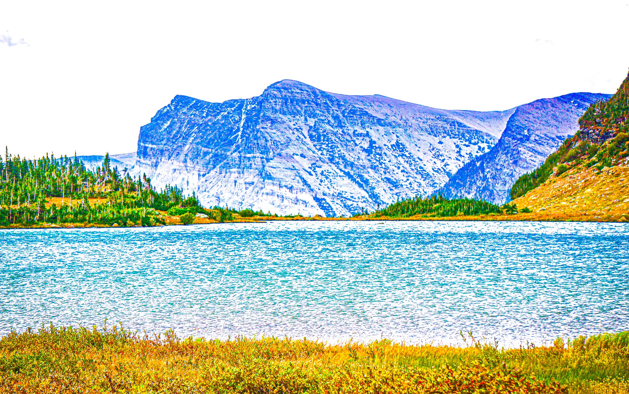 This image captures the glacial feel with this ice-cold pond filled from melted alpine snow and occasional rain as well as the frosty mountain range in the background. This image was taken around 9,500 ft.